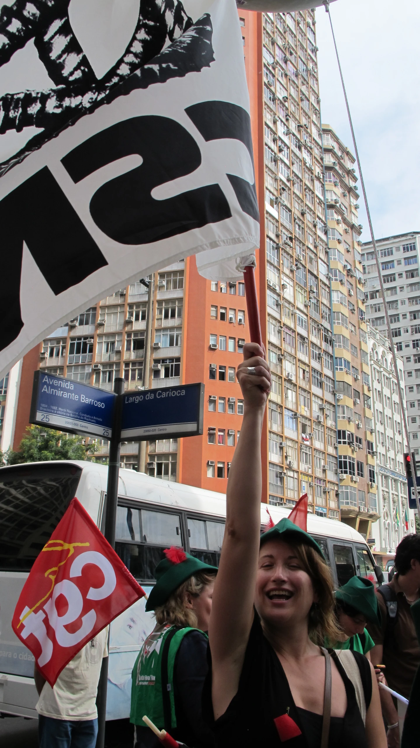 a group of people standing around and holding up some signs