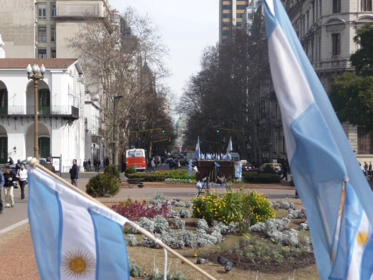 two flags are on the ground in a courtyard area