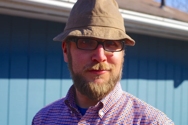 a man with a beard and mustache wearing a hat