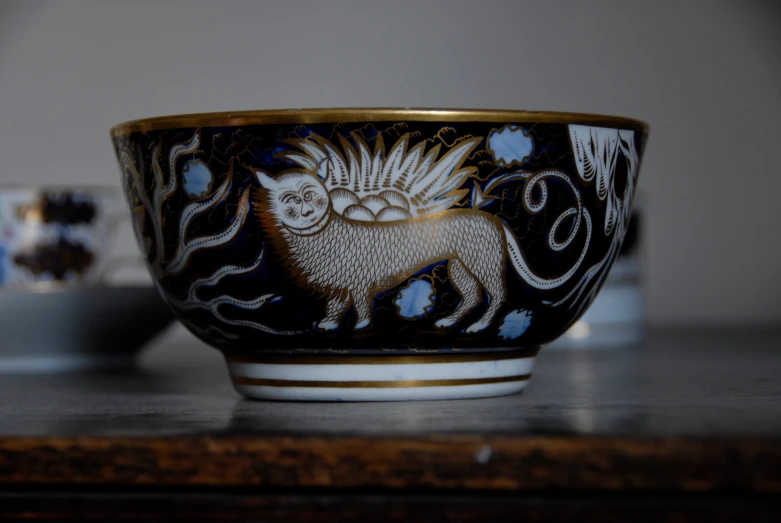 a bowl with animals painted on it sits on a table