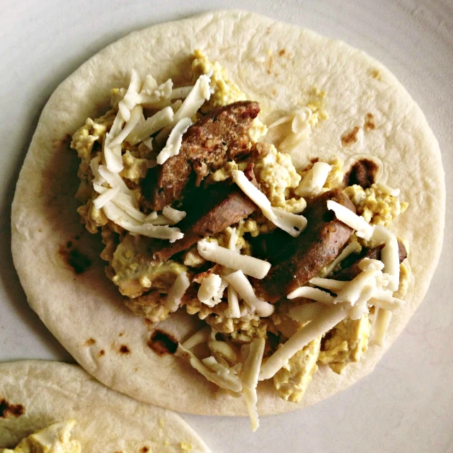 a couple of tortillas on top of a white plate