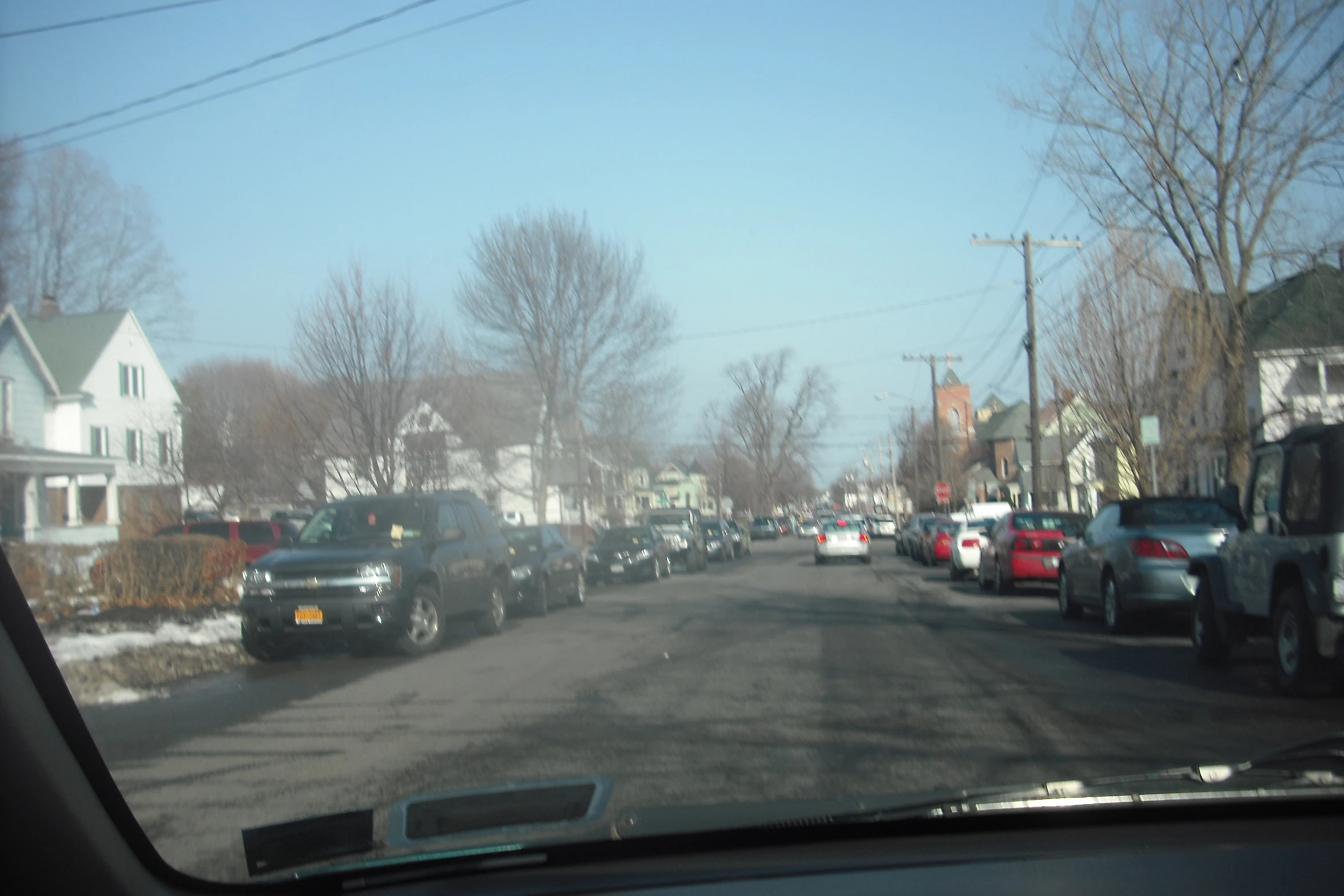 a street view looking down the middle with parked cars