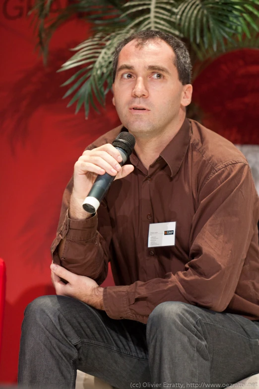 a man with a microphone speaking on stage