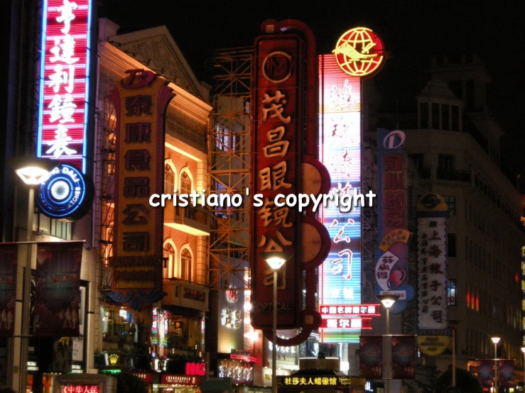 a city street filled with neon lights and large signs