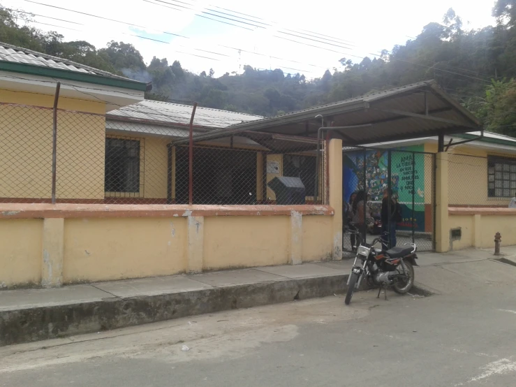 a man standing next to his bike outside a house