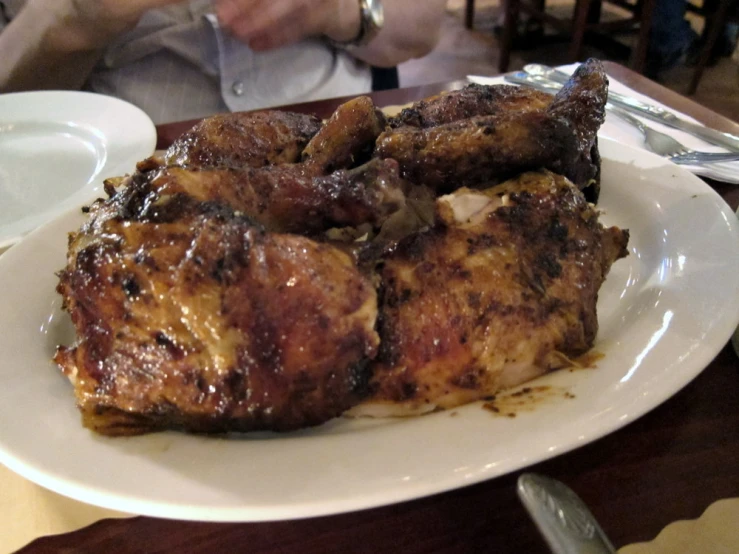 a plate that has some kind of meat on it