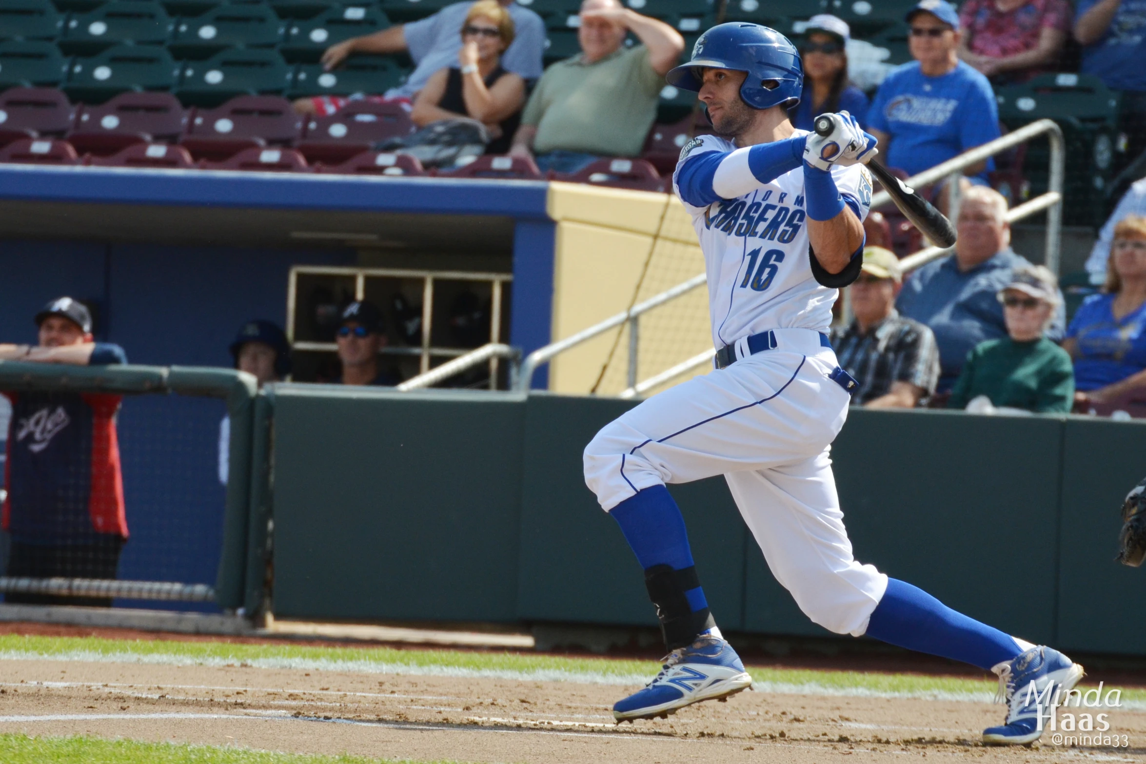 a baseball player swinging a bat at a baseball game