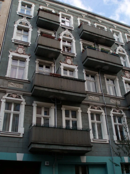 a large tall building with many balconies and a clock