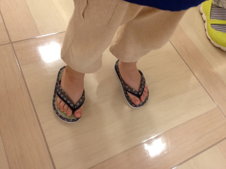 a person standing in sandals on a floor