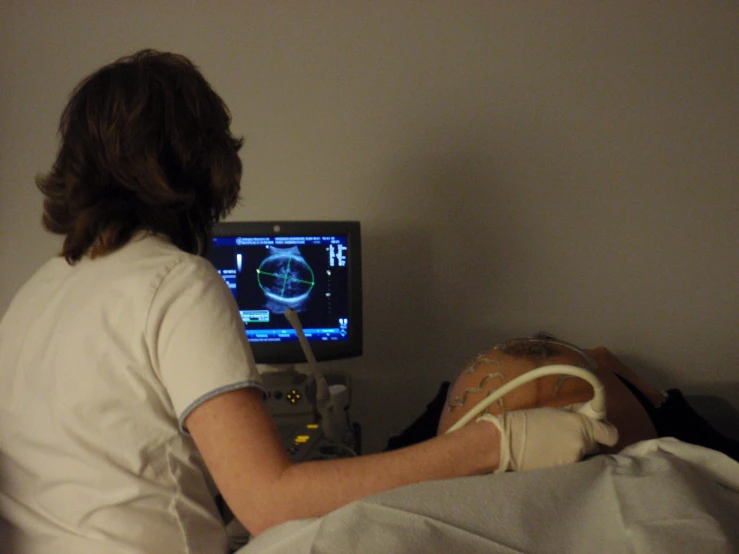 the nurse is checking the heartbeat of the patient
