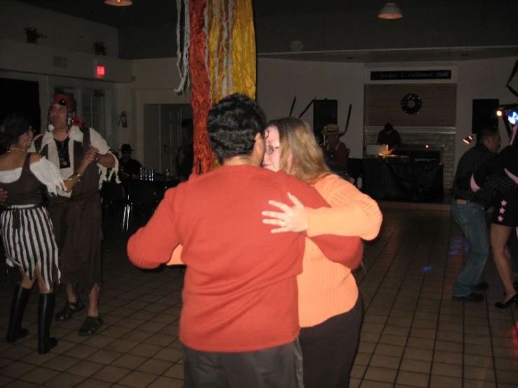 man and woman emce each other on a dance floor