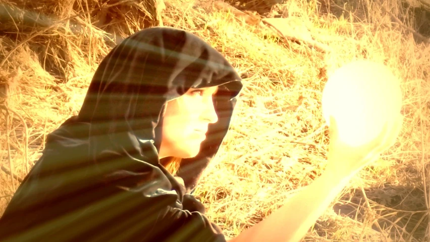 a person standing next to some brown grass