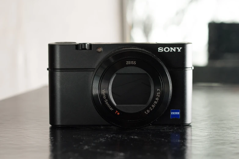 a black sony camera sitting on top of a table