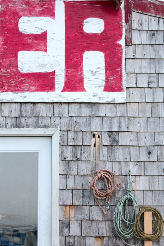 old signs hang on the side of a house