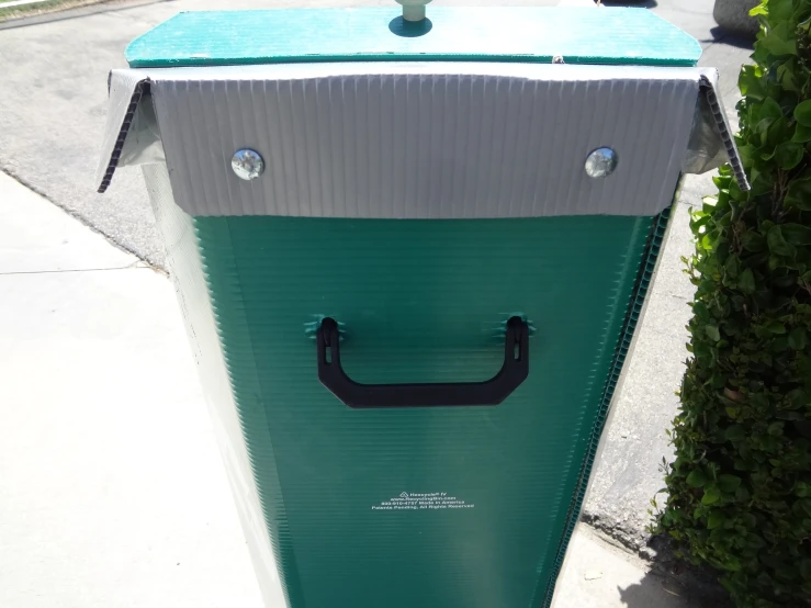 a blue and white cardboard box on the sidewalk