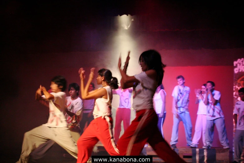 group of young people on stage in costume dancing