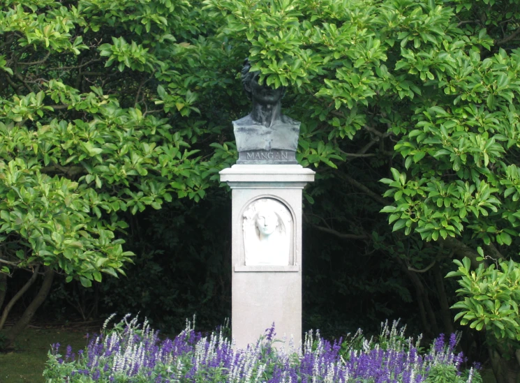 an image of a monument with flowers and plants surrounding it