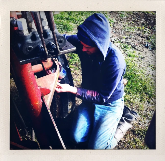 a person that is trying to fix soing on the back of a truck