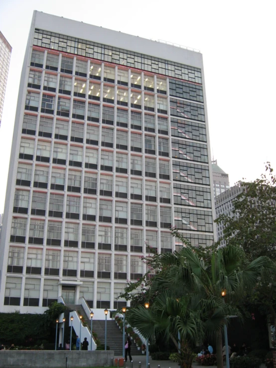 the large building is next to stairs and trees