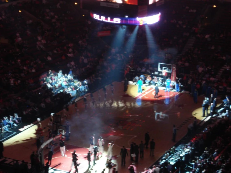 basketball court with players and smoke from the fire at a game