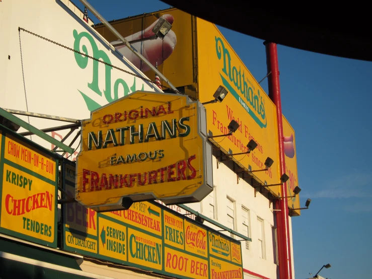 a group of neon signs that are on the side of a building