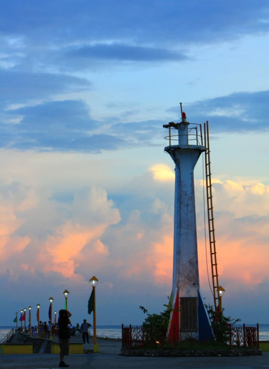 there is a light house and ladder on the side of the road