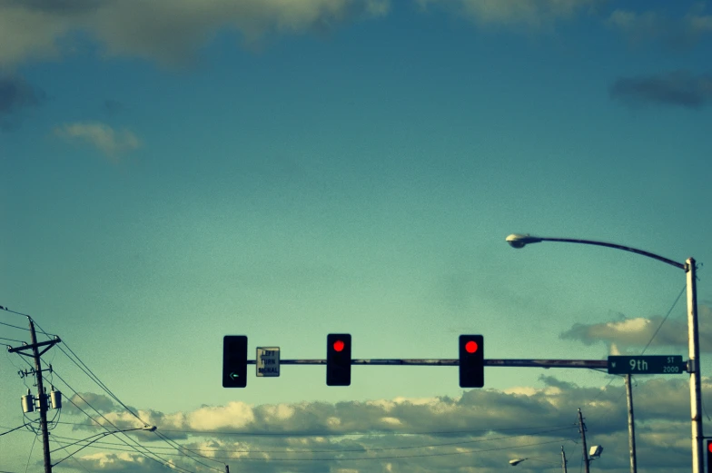 a street light with red lights hanging over it