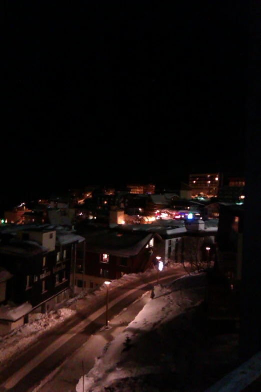 an urban area illuminated at night with light snow