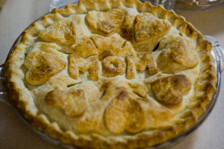 a pie covered in many heart shapes on top of a counter