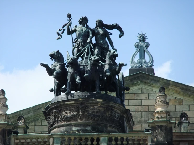 statue atop a stone pillar with statues on top