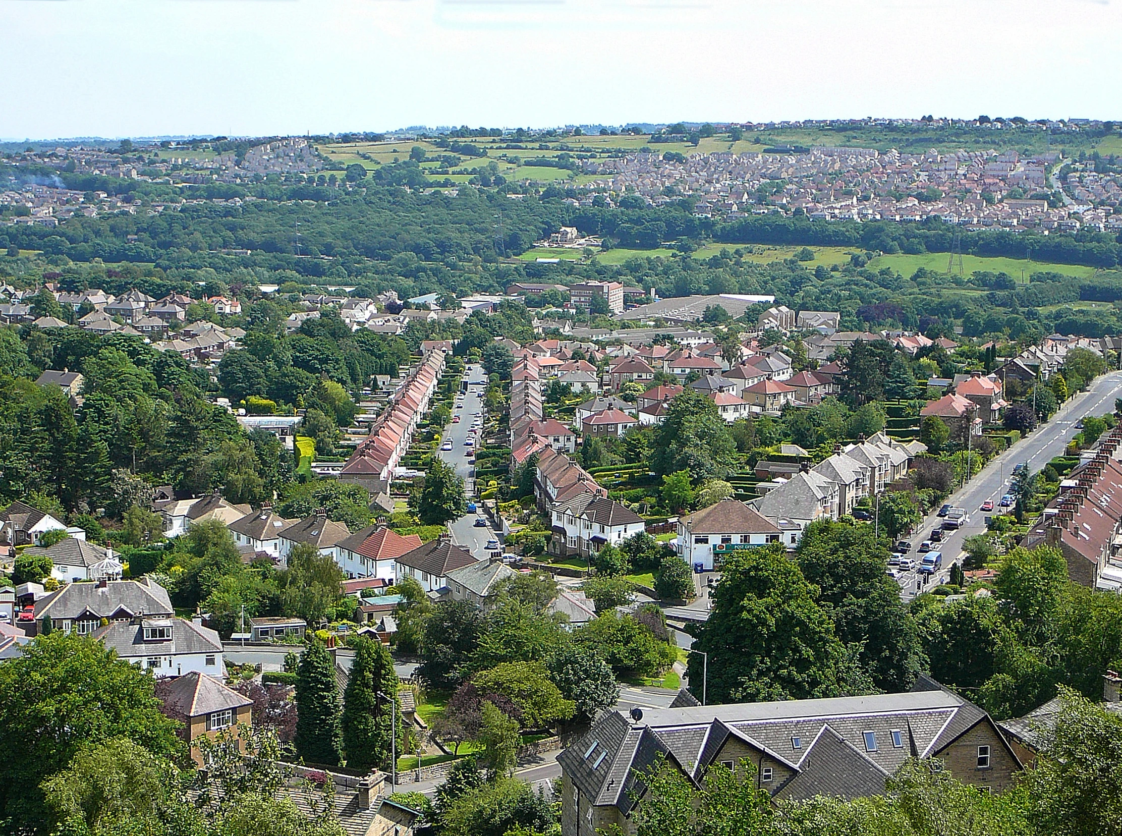 a view of a town and the surrounding hills