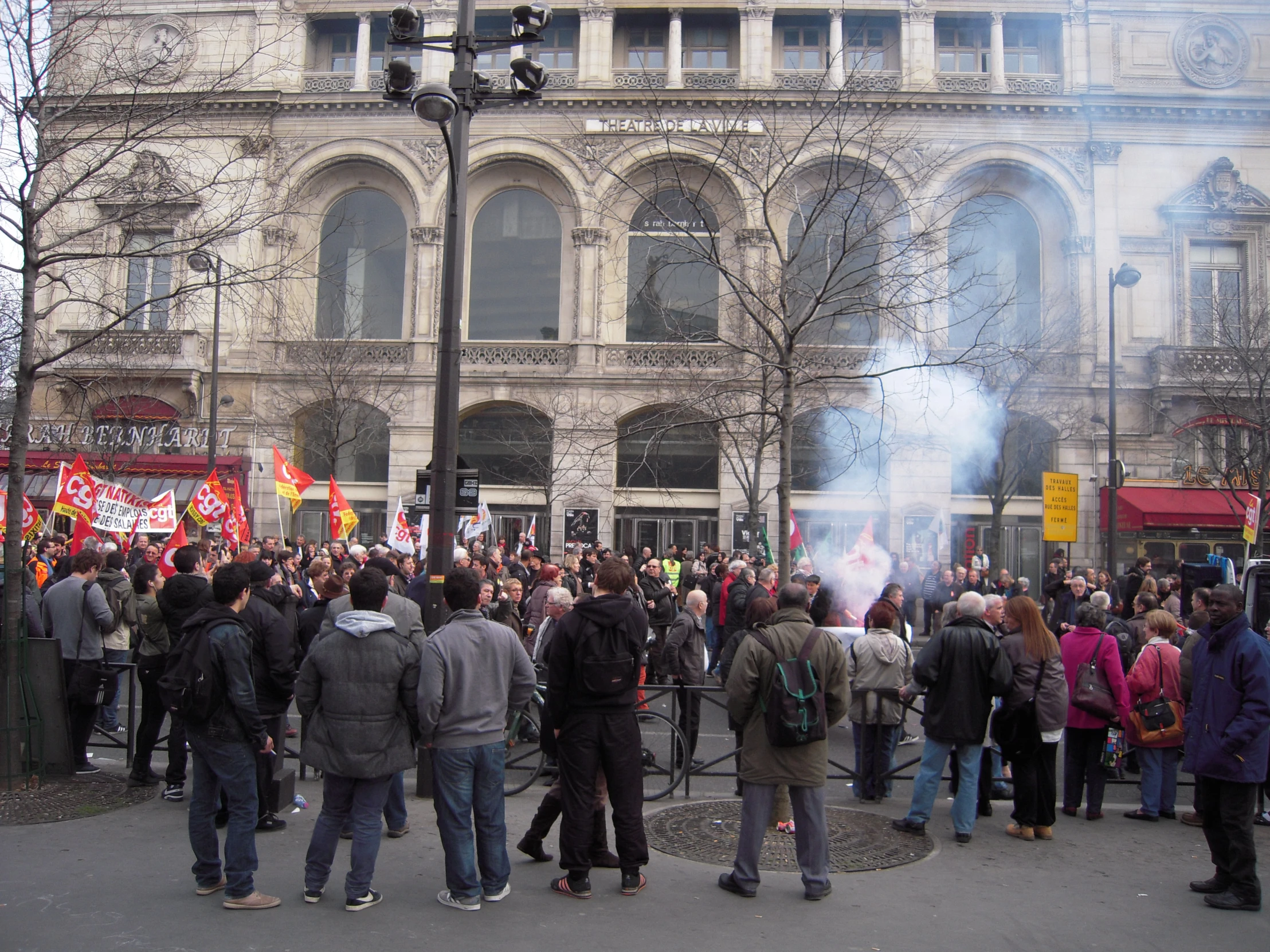 people gathered outside a building in the cold