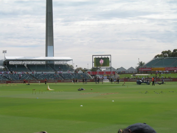 two groups of people are practicing cricket at the ground