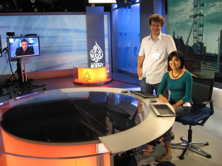 a couple is sitting at a television set