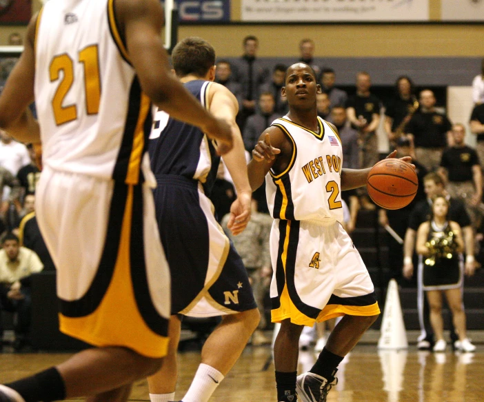 two players at a basketball game on a court with a crowd watching them