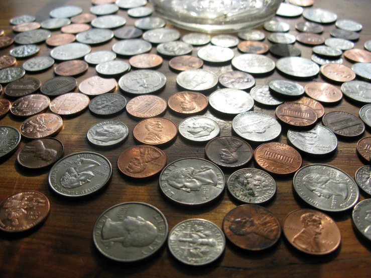 a number of pennets on a table with an empty dish on the side