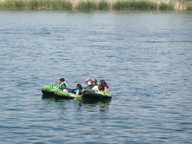 people on small boats on the water