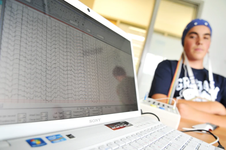 a person sits in front of a computer screen