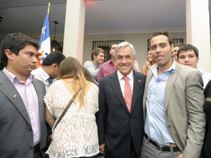 three men pose for a pograph together in suits and ties