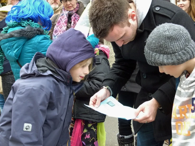 a man reading a paper with a young child