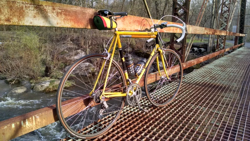 a bike with a long tube rack is locked up on a bridge