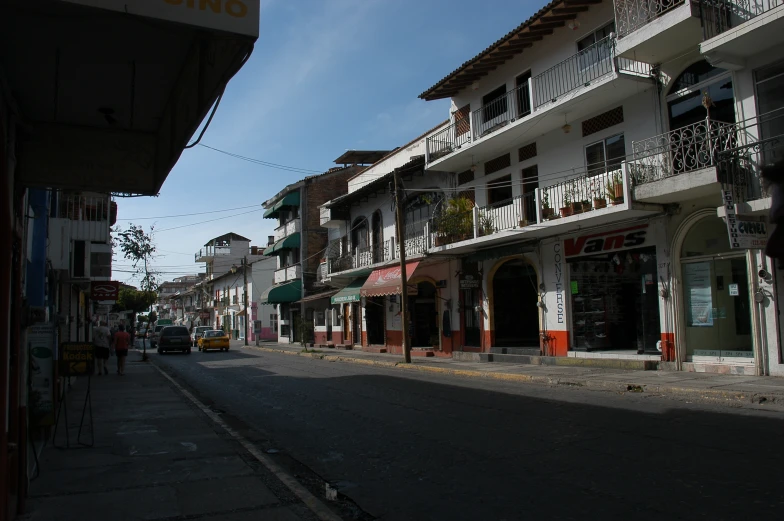 a street lined with stores and buildings and cars