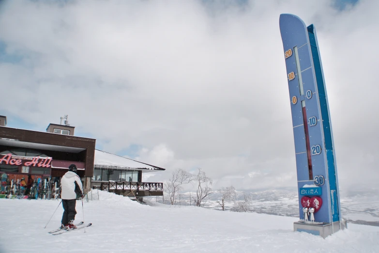 a man on skis near a big sign for the ski area