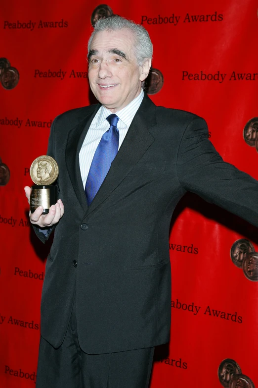 a man in a suit is holding a golden ball