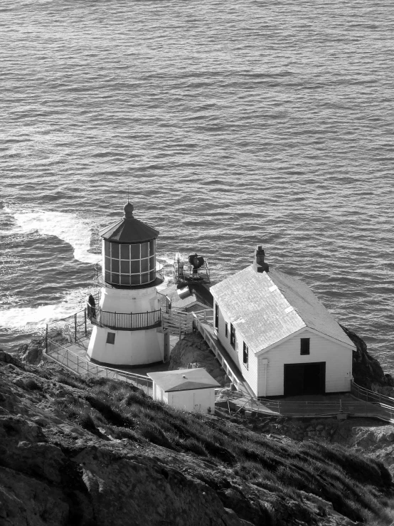 the lighthouse is located near the ocean on the rocks