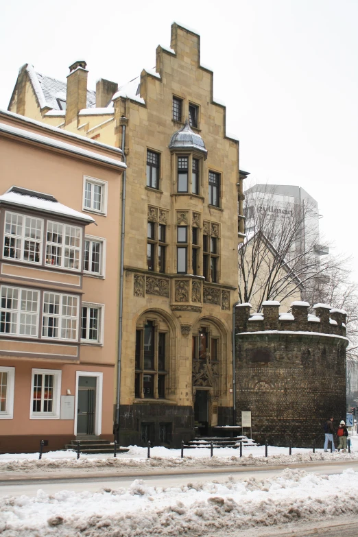 an old building is standing out in the snow