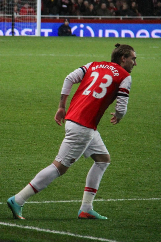 two soccer players stand near each other on a field