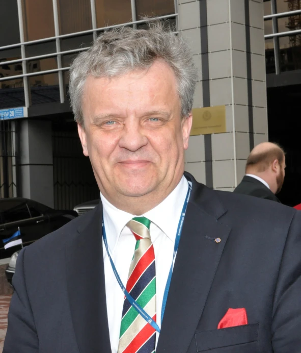 a close up of a person wearing a suit and tie