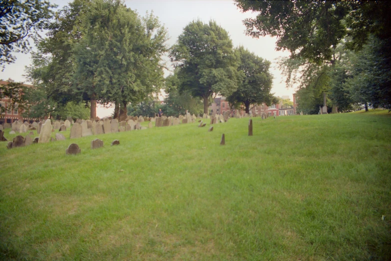 an old graveyard is shown in the grass