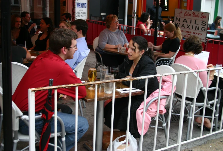 people sitting at a table outside eating food